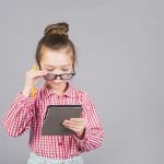 cute-little-girl-glasses-using-tablet-scaled-pacc1e5ukehj4hu359gmrp2l22ekad9fj5gnx87ckc